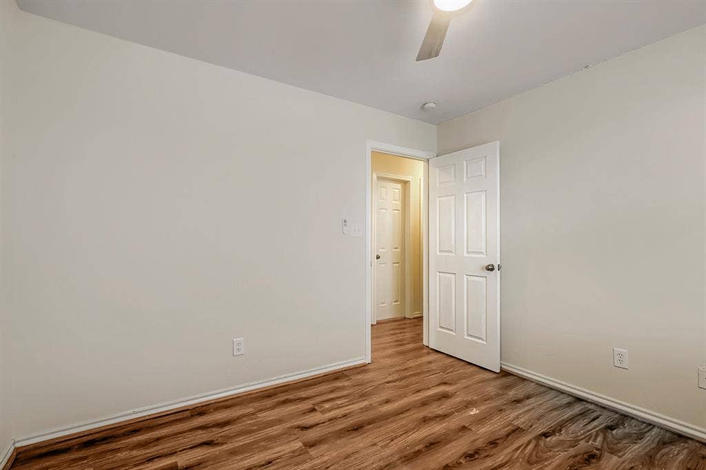 112 Sebastian Lane, Josephine, TX 75173 Interior space featuring wood-finish flooring, neutral wall paint, and a six-panel interior door