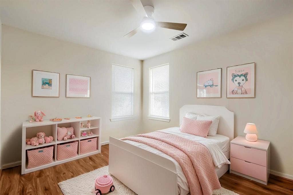 112 Sebastian Lane, Josephine, TX 75173 Virtually Staged Bedroom interior featuring neutral-toned walls, laminate wood-finish flooring, dual windows, and an overhead ceiling fan with integrated lighting