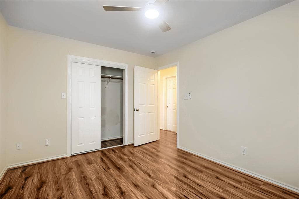 112 Sebastian Lane, Josephine, TX 75173 Wood-finish flooring, ceiling fan with integrated light fixture, and closet with sliding paneled doors