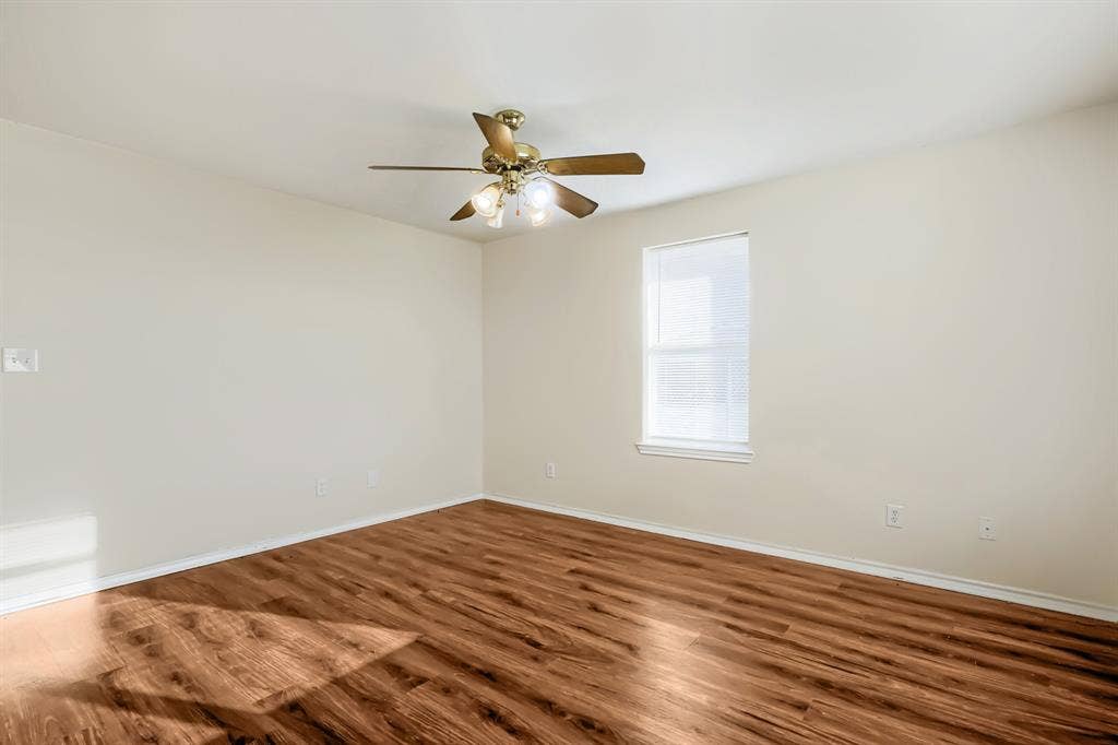 112 Sebastian Lane, Josephine, TX 75173 Room featuring laminate wood-finish flooring, a single window, and a ceiling-mounted light fixture with a fan