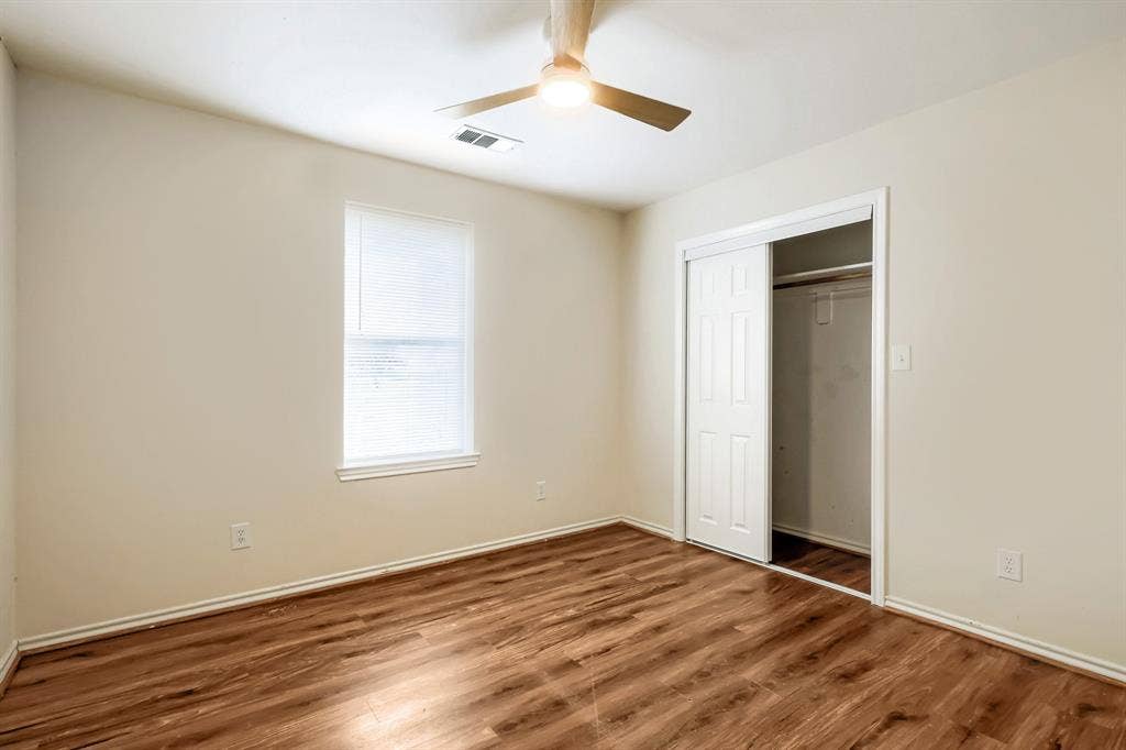 112 Sebastian Lane, Josephine, TX 75173 Interior space featuring wood-finish flooring, a neutral color palette, a ceiling fan with integrated lighting, and a closet with sliding doors