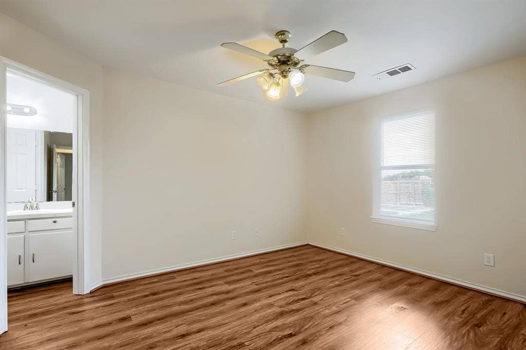 112 Sebastian Lane, Josephine, TX 75173 Room featuring wood-finish flooring, a multi-blade ceiling fan with integrated lighting, and a single-hung window with white casing