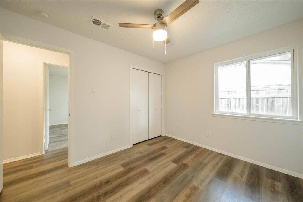 1903 Arvada Drive, Richardson, TX 75081 Interior room featuring wood-finish flooring, a ceiling fan with integrated lighting, and a double-door closet