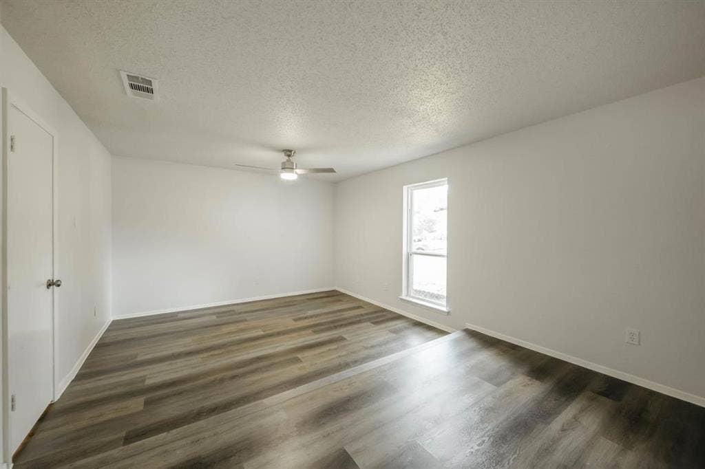 1903 Arvada Drive, Richardson, TX 75081 Neutral wall palette with wood-finish flooring, recessed lighting, and a brushed nickel ceiling fan