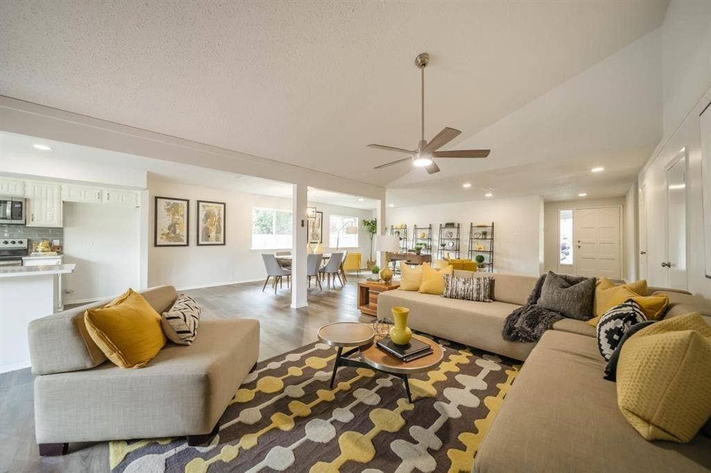 1903 Arvada Drive, Richardson, TX 75081 Vaulted ceiling, open-concept floor plan, recessed lighting, wood-finish flooring, and brushed metal ceiling fan