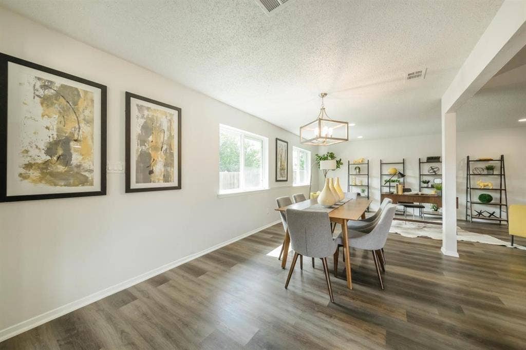 1903 Arvada Drive, Richardson, TX 75081 Wood-finish flooring, neutral wall color, oversized windows, and a rectangular multi-light pendant fixture