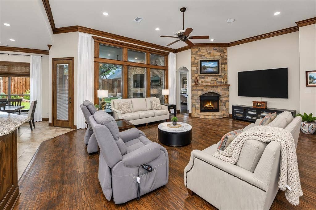 6620 Cedar Grove Drive, North Richland Hills, TX 76182 Great room with wood flooring and a wall of windows looking out over the back yard.