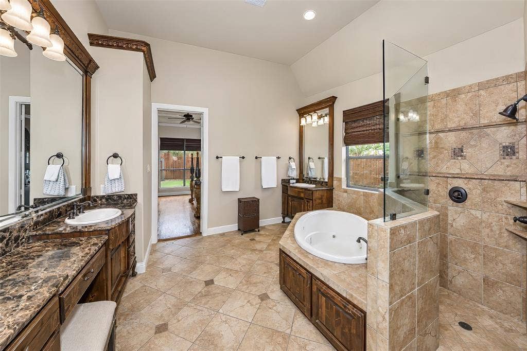 6620 Cedar Grove Drive, North Richland Hills, TX 76182 The ensuite primary bath features a walk in shower, separate vanities and tub.