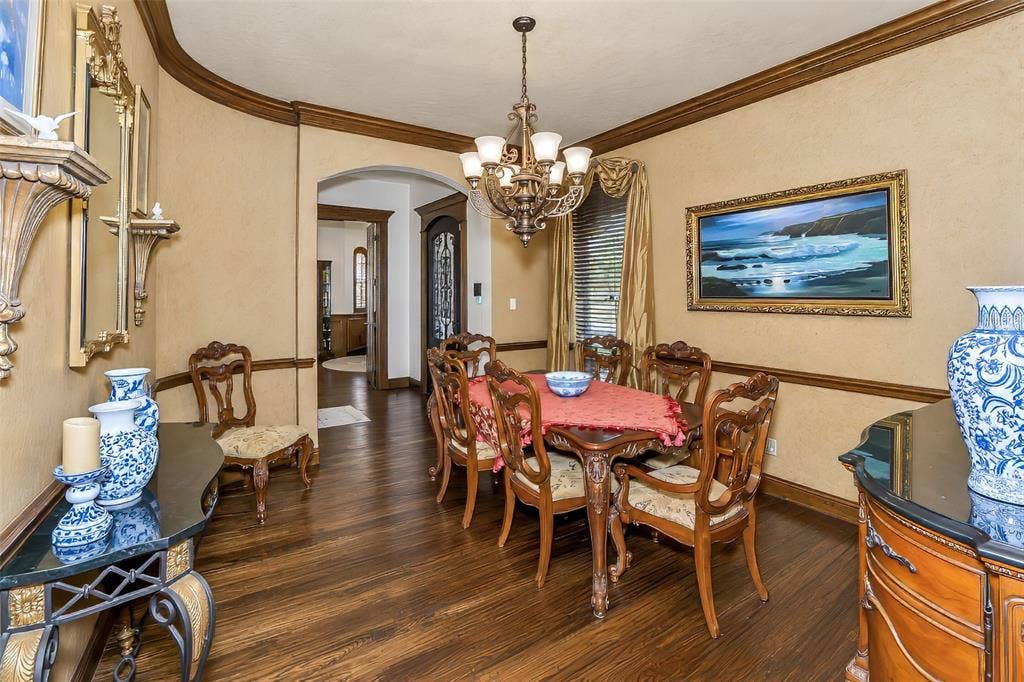 6620 Cedar Grove Drive, North Richland Hills, TX 76182 Beautifully appointed formal dining with extensive millwork, chandelier and custom drapery.