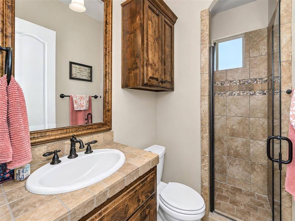 6620 Cedar Grove Drive, North Richland Hills, TX 76182 This guest bathroom downstairs features a custom shower and built in vanity.