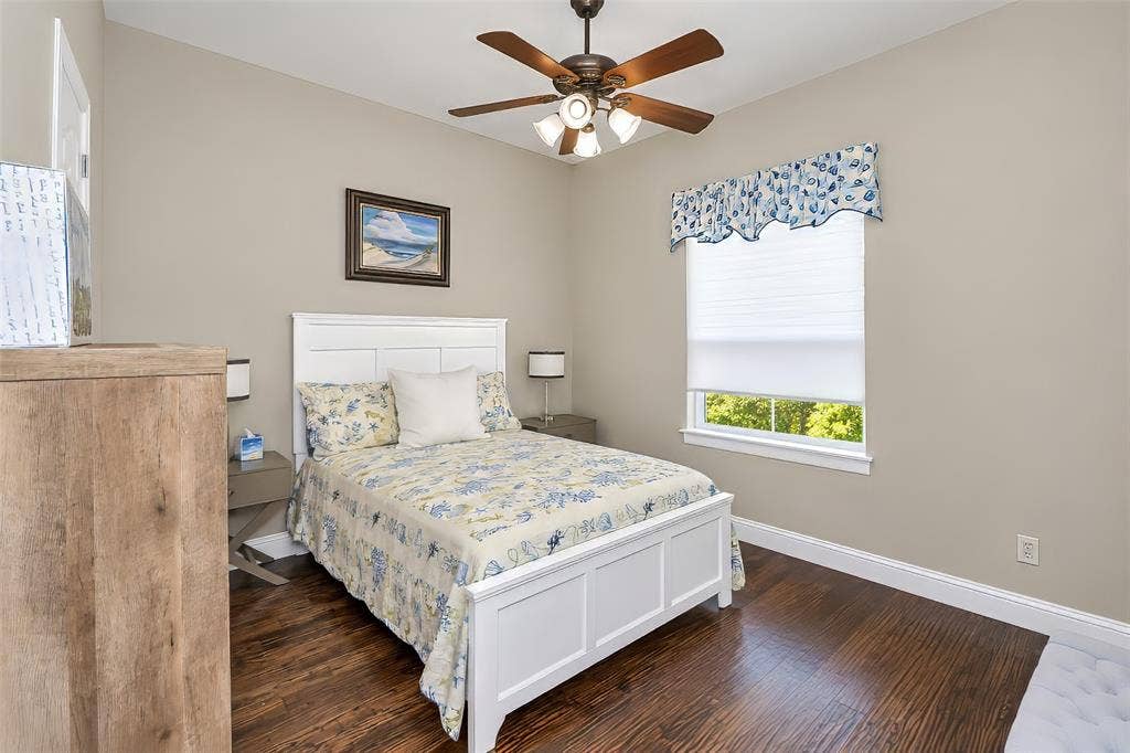 6620 Cedar Grove Drive, North Richland Hills, TX 76182 The downstairs guest bedroom features wood flooring and a window to the back yard.