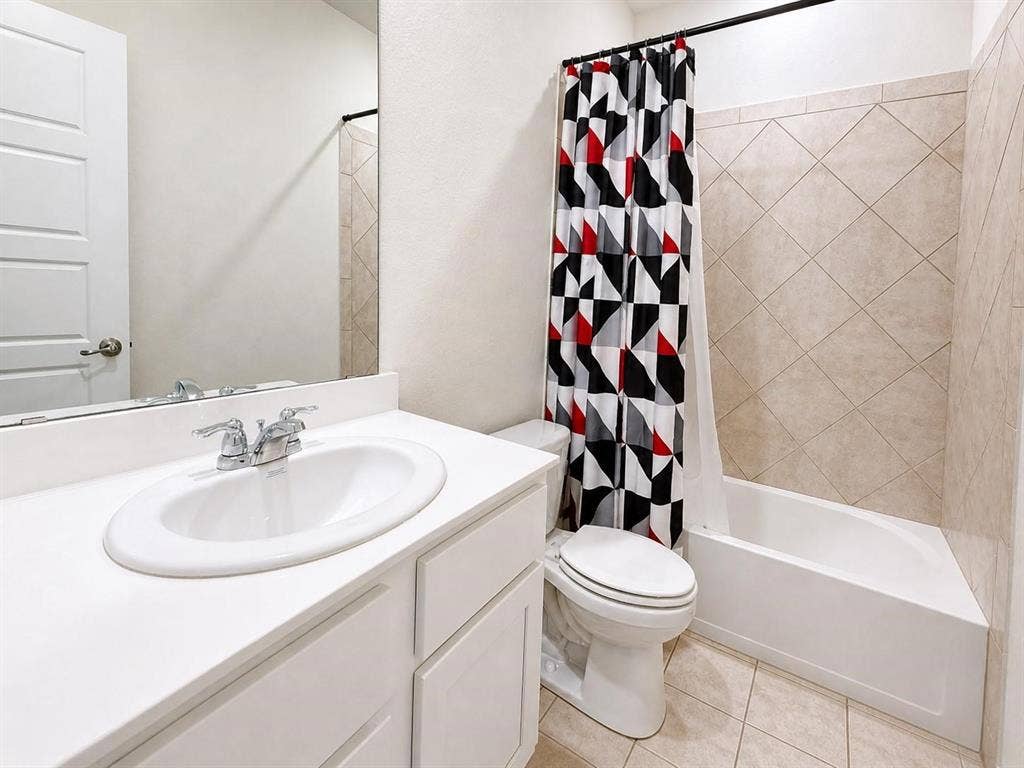 Secondary, full bathroom with vanity and shower-tub combo