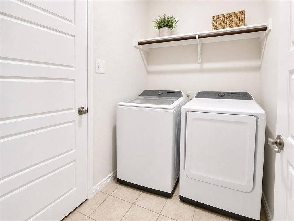 Full-size washer and dryer area with shelving