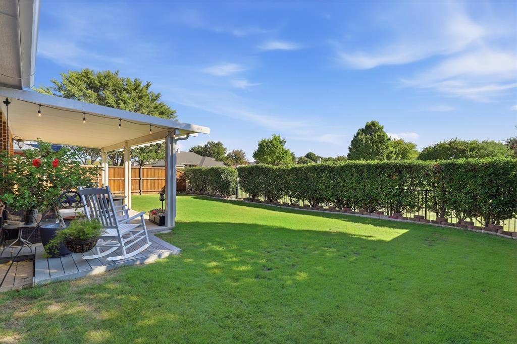 A neatly trimmed hedge adds privacy along the rear fence, with gated access to the greenbelt & walking trails.