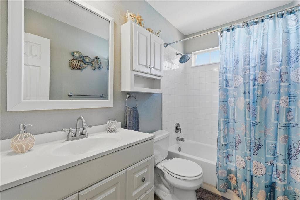 The upstairs full bath includes vanity storage & a tiled tub/shower combination.