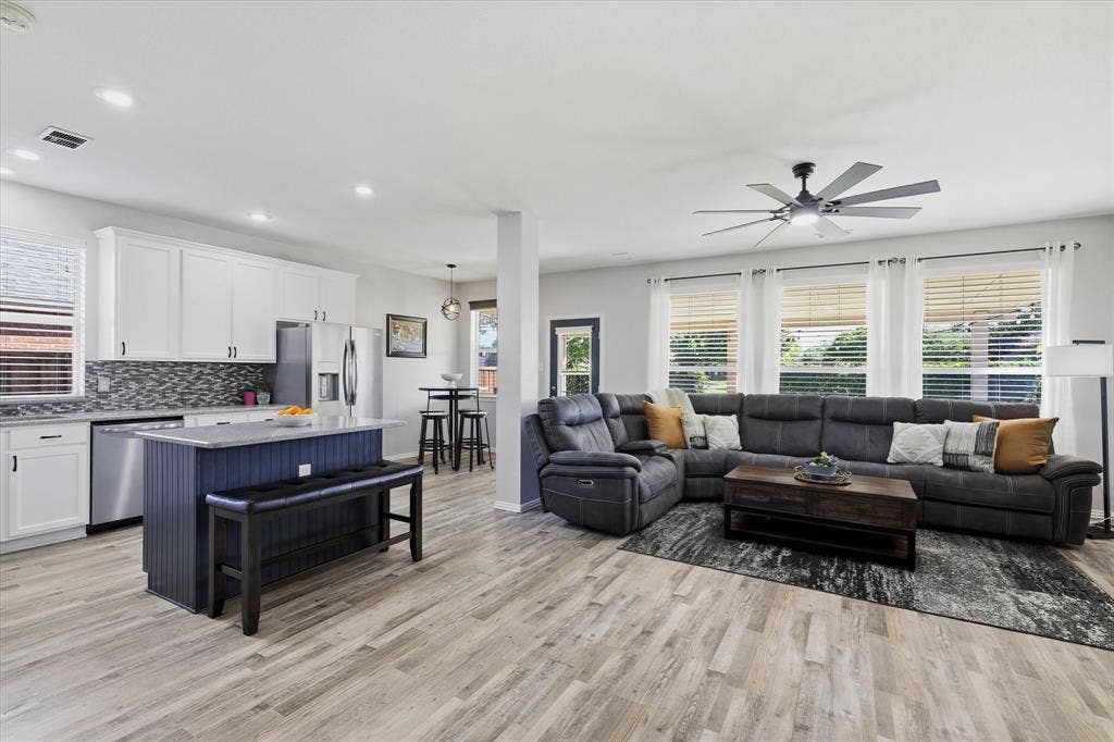 The kitchen opens to the family room, with island seating keeping conversation flowing between the two spaces.