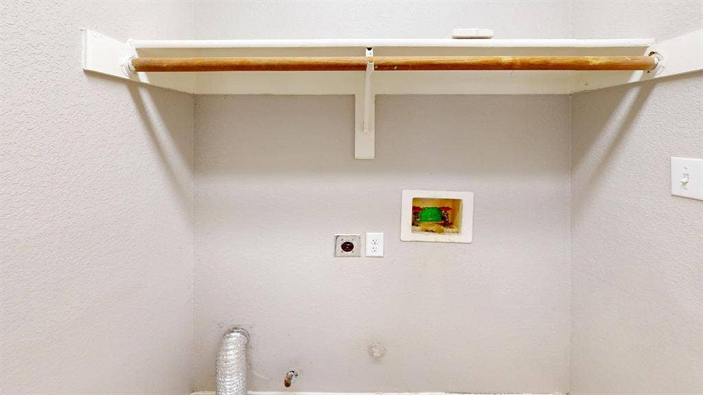 5210 Welbeck Court, Garland, TX 75043 Dedicated laundry area featuring a recessed utility box, dedicated electrical outlet, and an overhead shelf with a mounted garment rod