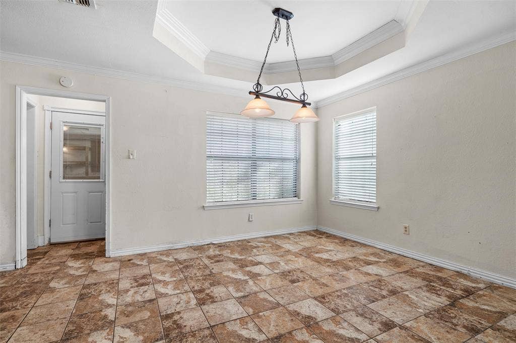 Coffered ceiling featuring a suspended dual-light metal fixture, tile flooring, and windows with integrated blinds