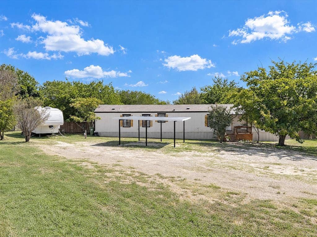 4113 Goliad Drive, Granbury, TX 76048 Parking Galore! Detached carport, rv parking with full hookups, shade trees.