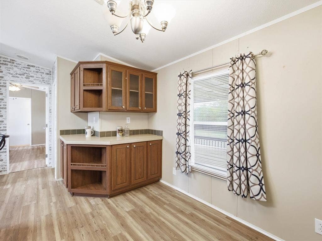 4113 Goliad Drive, Granbury, TX 76048 Bar and storage with dining space.