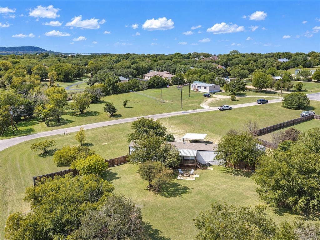 4113 Goliad Drive, Granbury, TX 76048 HUGE corner lot, possibilities are endlless. Short golf cart ride to the lake and marina.