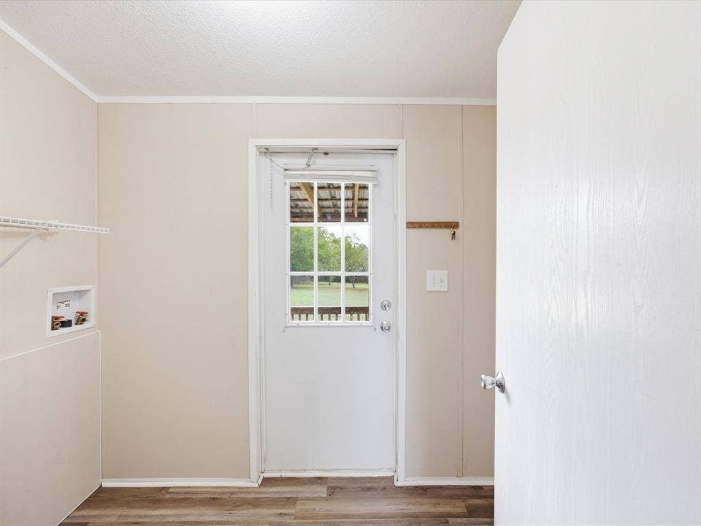 4113 Goliad Drive, Granbury, TX 76048 Big utility room with space for full size washer dryer and second fridge or freezer. Door to the backyard.