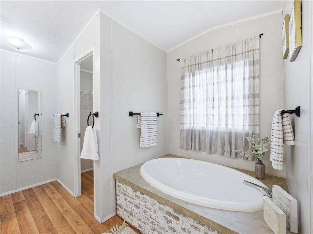4113 Goliad Drive, Granbury, TX 76048 Oversized ensuite bath with separate vanities, garden tub, shower and two walk in closets.