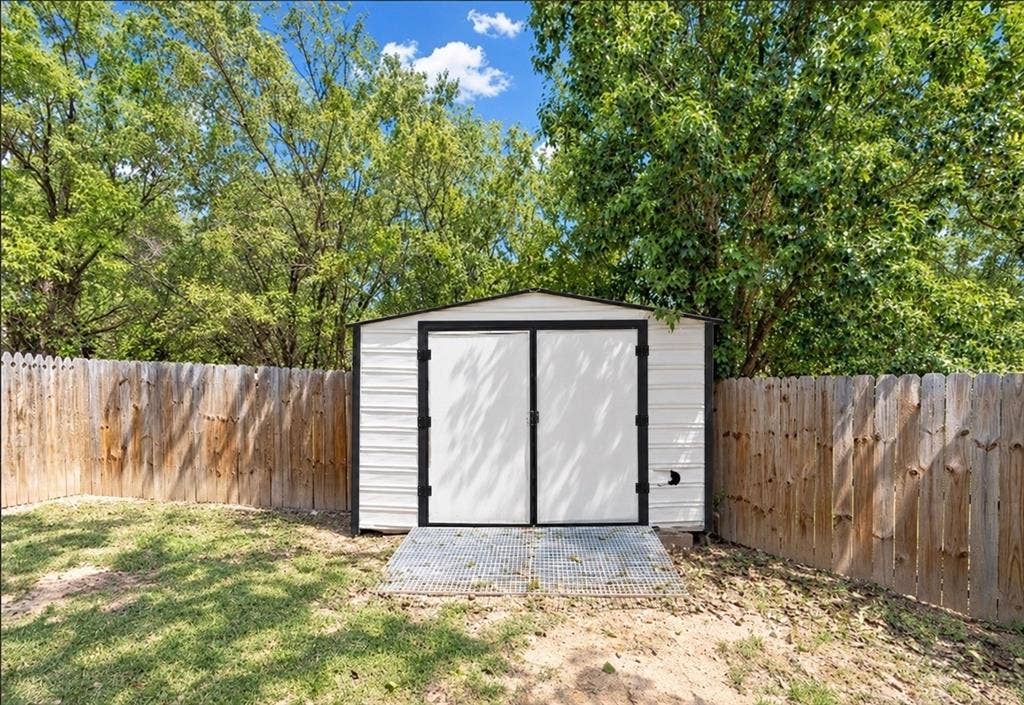 4113 Goliad Drive, Granbury, TX 76048 12x30 shop with electric, double doors, side door and ramp. Fits your tools, atv's, golf cart and mowers.