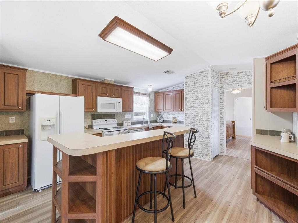 4113 Goliad Drive, Granbury, TX 76048 Kitchen with island, eat at bar and dining table space. Window over the sink.
