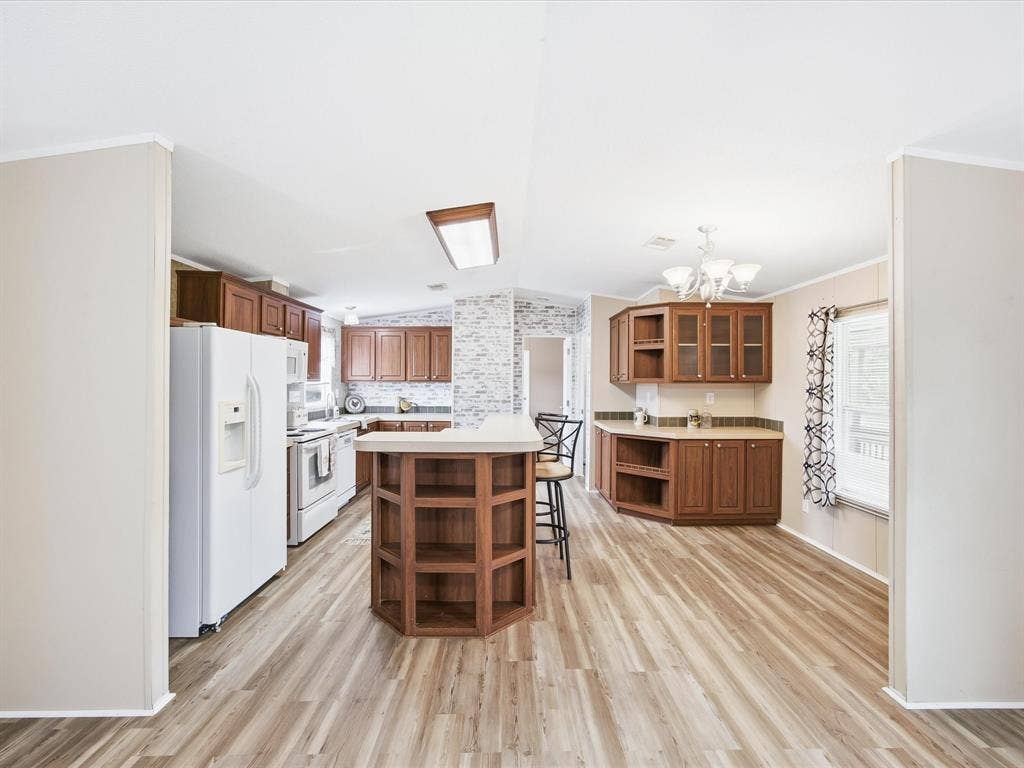 4113 Goliad Drive, Granbury, TX 76048 Kitchen with island, eat at bar and dining table space. Window over the sink.