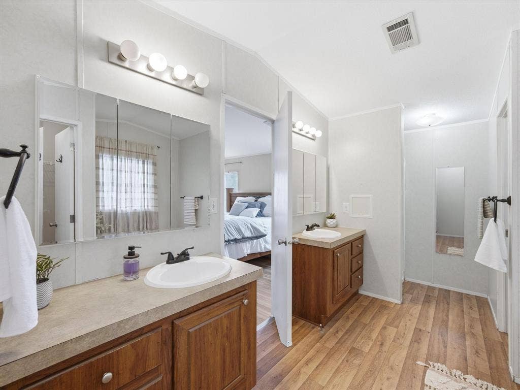 4113 Goliad Drive, Granbury, TX 76048 Oversized ensuite bath with separate vanities, garden tub, shower and two walk in closets.
