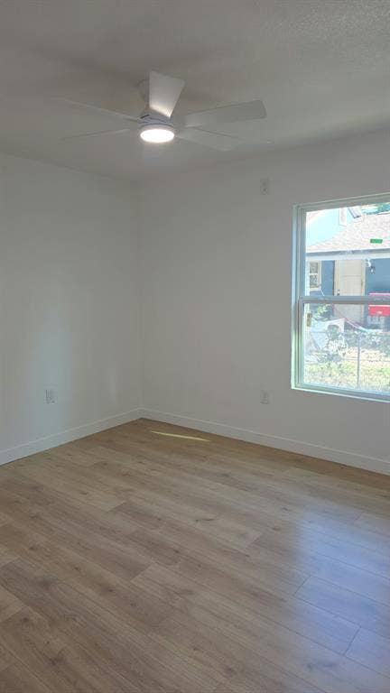 3426 Edgewood Street, Dallas, TX 75215 Interior room featuring wood-finish flooring, a neutral color palette, and a white ceiling fan with integrated lighting