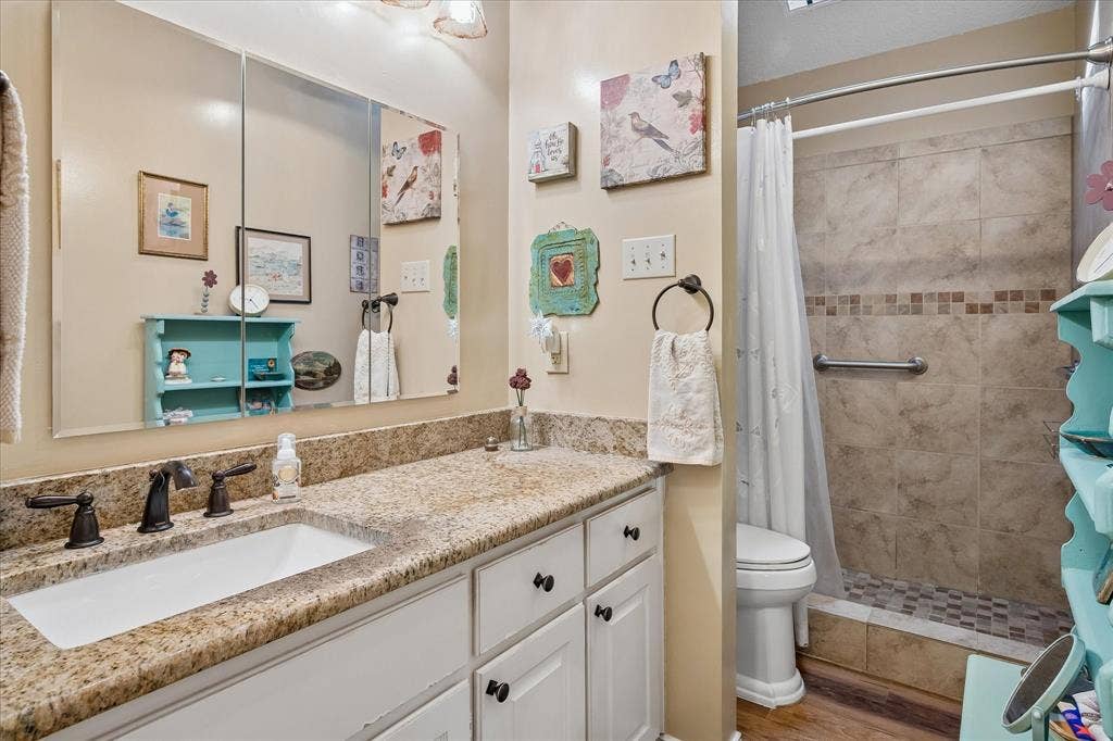 8920 Ashcraft Drive, North Richland Hills, TX 76182 Updated secondary bathroom with granite counter tops and a walk in shower.