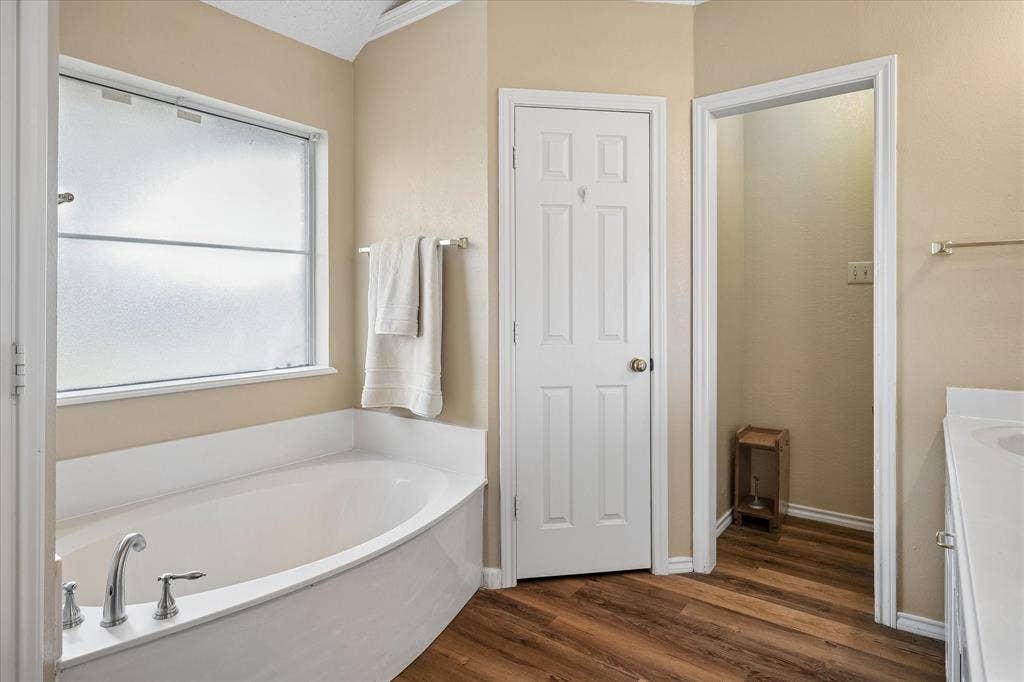 8920 Ashcraft Drive, North Richland Hills, TX 76182 Spacious primary bath with a garden tub, separate closets, and a walk in shower.