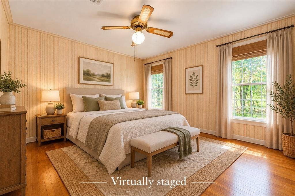 Wood-finish flooring, vertical-patterned wallpaper, dual windows with wood-tone window shades, and a ceiling-mounted fan with integrated lighting