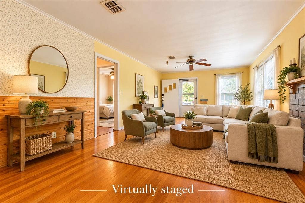 Living area featuring wood-finish flooring, wood wall paneling with decorative wallpaper, and a brick fireplace