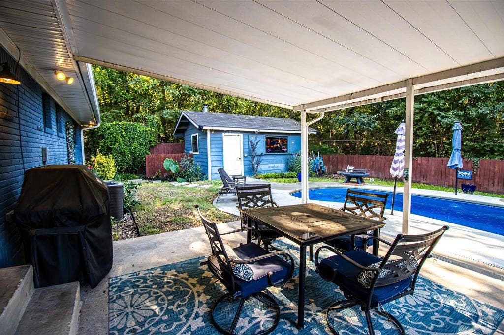 1040 Wedgewood Drive, Woodway, TX 76712 Covered concrete patio, in-ground swimming pool, detached workshop, and wood-panel fencing