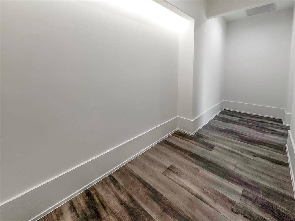 Unfurnished room featuring dark wood-type flooring
