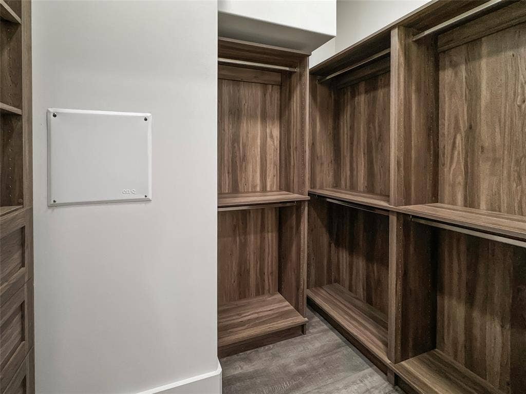 Walk in closet featuring dark hardwood / wood-style flooring