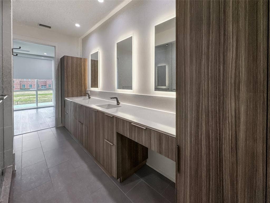 Bathroom with tile patterned flooring and vanity