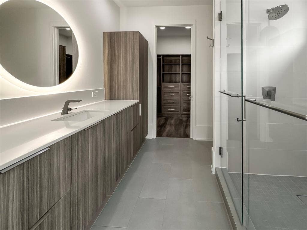 Bathroom featuring vanity, tile patterned floors, and walk in shower