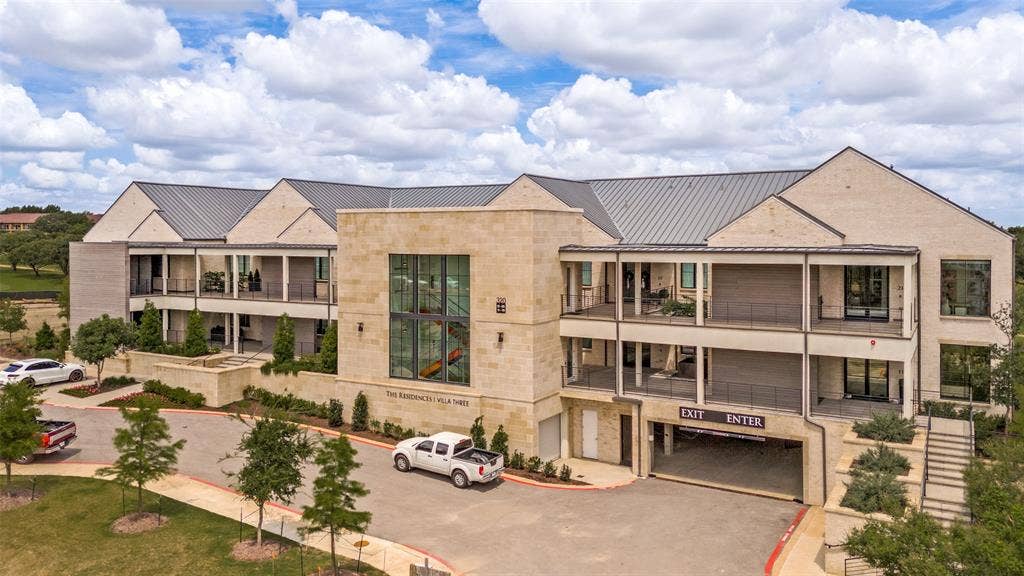 320 N O Connor Ridge Boulevard, #21, Irving, TX 75038 The striking exterior showcases a timeless blend of natural stone, clean architectural lines and a distinctive metal roof creating a modern design with enduring appeal