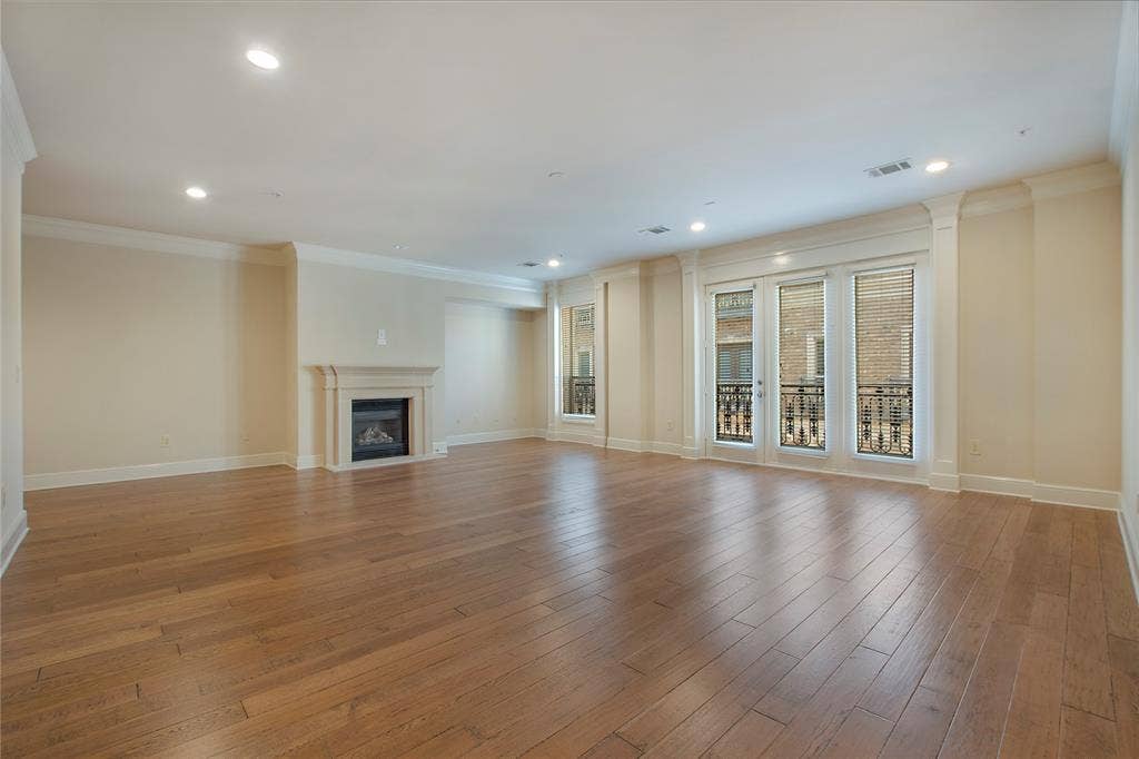 Unfurnished living room with light hardwood / wood-style floors and ornamental molding