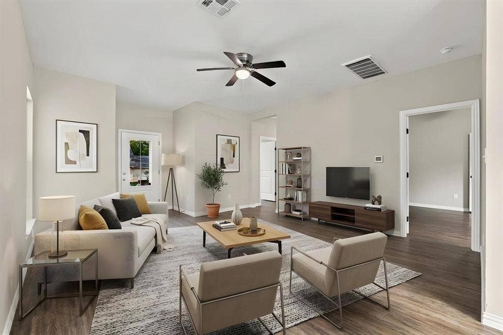 1116 S 6th Avenue, Denison, TX 75021 Neutral-toned walls paired with wood-finish flooring, featuring a ceiling fan with integrated light fixture and multi-panel door entry
