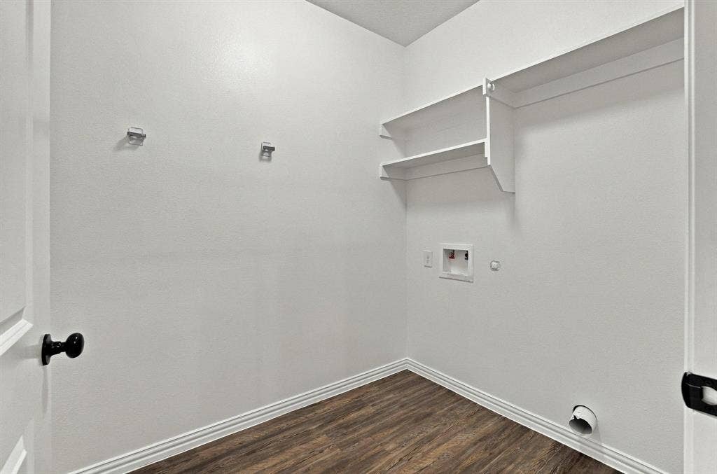 1116 S 6th Avenue, Denison, TX 75021 Utility room featuring wood-finish flooring, white walls, and built-in white shelving
