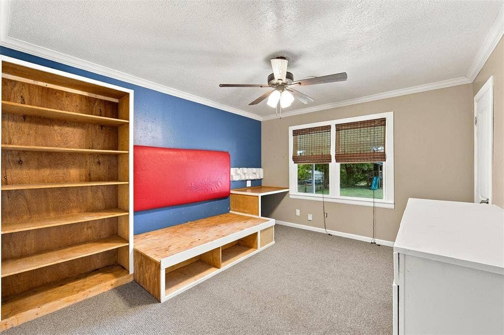 front bedroom with custom built captains bed, shelving, desk and dresser