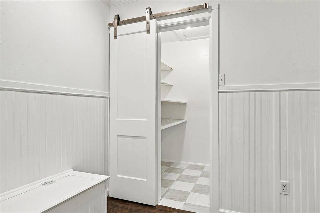walk in pantry with custom built shelving and new flooring