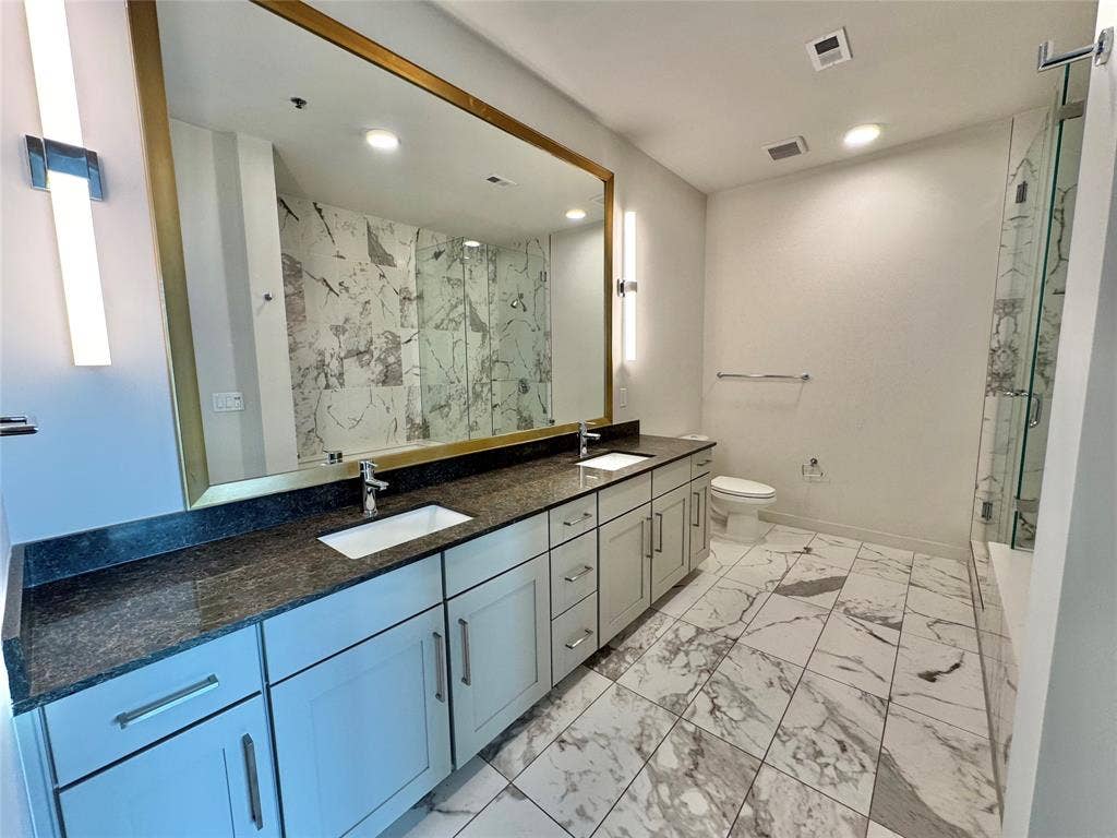 6911 Cowboys Way, #913, Frisco, TX 75034 Bathroom featuring vanity, toilet, and walk in shower