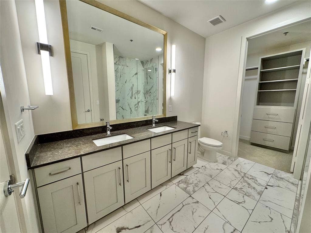 6911 Cowboys Way, #913, Frisco, TX 75034 Bathroom with vanity, toilet, and walk in shower