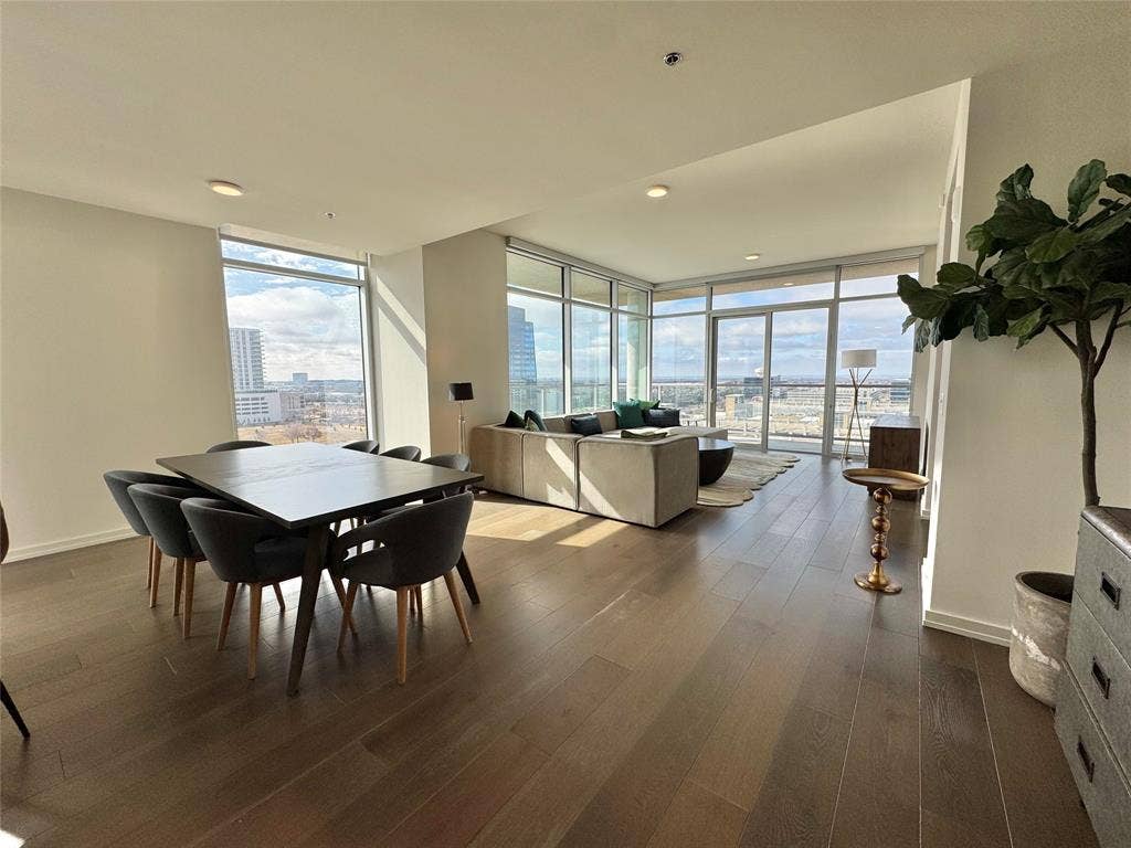 6911 Cowboys Way, #913, Frisco, TX 75034 Dining area with expansive windows and dark hardwood / wood-style flooring